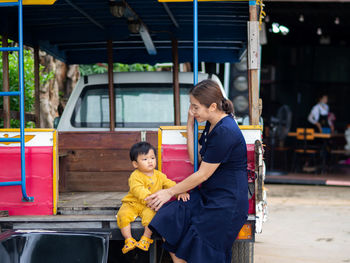 Rear view of woman sitting in bus