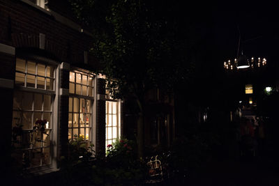 Man in illuminated building at night