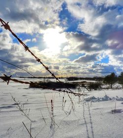 Scenic view of snow field against sky