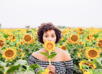 Portrait of a girl holding yellow flower