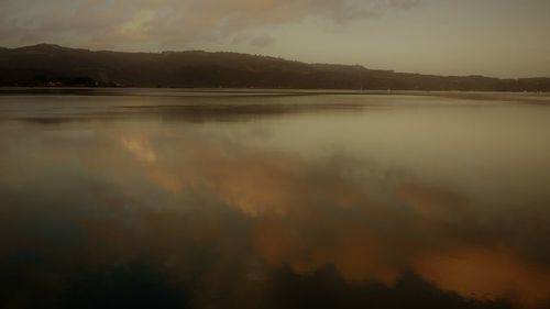 Scenic view of lake against sky during sunset
