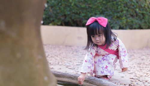 Girl playing at fountain