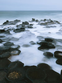 Rocks in sea against sky