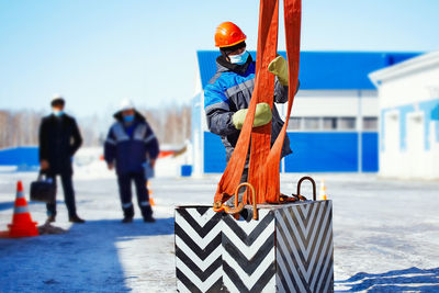 Rear view of man standing on snow