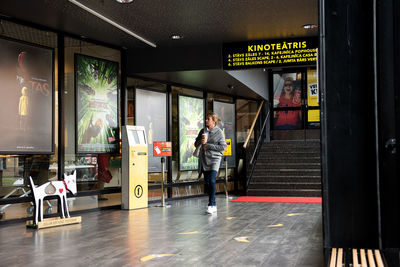 Man standing on illuminated underground walkway