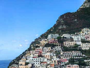 High angle view of cityscape by sea against sky