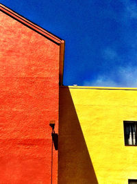 Low angle view of building against blue sky