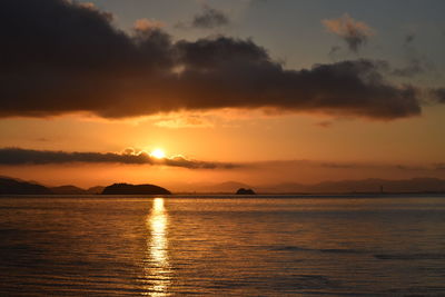 Scenic view of sea against romantic sky at sunset