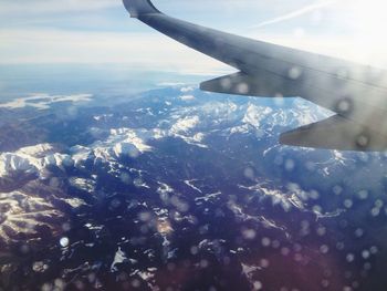 Cropped image of airplane wing over landscape