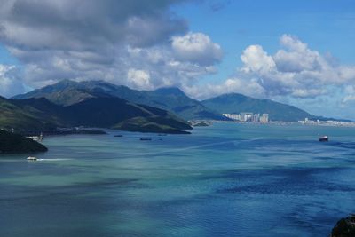 Scenic view of sea and mountains against sky