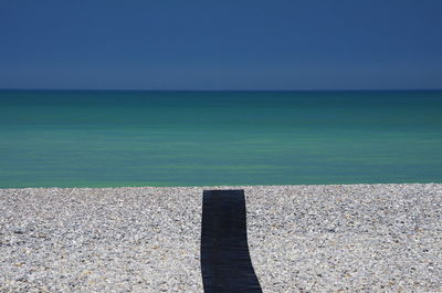 Scenic view of sea against clear blue sky