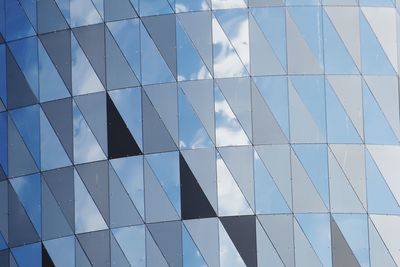 Low angle view of modern building against blue sky