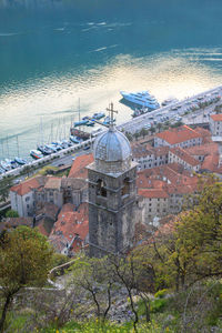 High angle view of buildings by sea