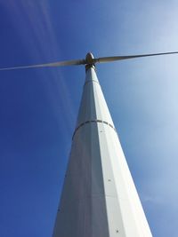 Low angle view of windmill against clear blue sky