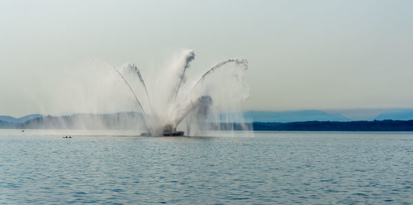 A fire boat spray water in seattle, washington.