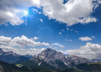 Scenic view of mountains against blue sky