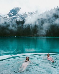 Couple swimming in water