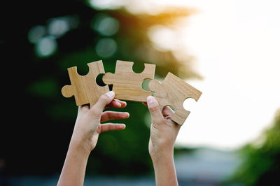 Cropped hand holding jigsaw puzzle