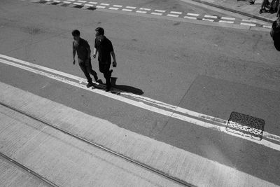 High angle view of people walking on road