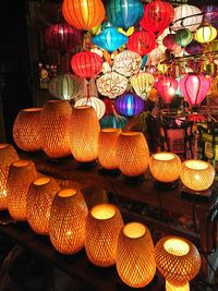 Illuminated lanterns hanging in market for sale
