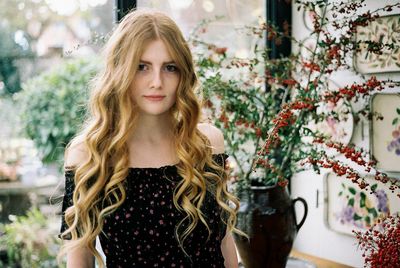 Portrait of young woman with long blond hair