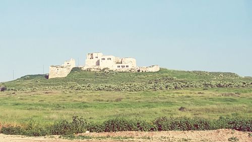 Built structure on hill against clear sky