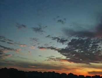 Low angle view of silhouette trees against sky at sunset