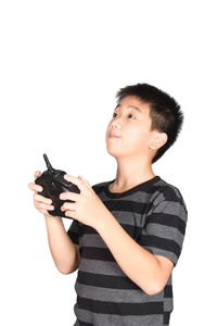 Happy boy looking away against white background