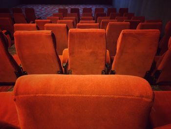 High angle view of empty red chairs in movie theater