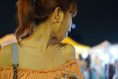 Woman looking away outdoors at night