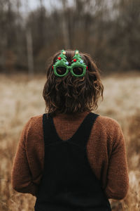 Rear view of woman wearing christmas glasses