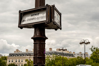 Low angle view of sign against sky