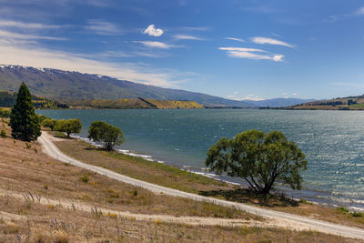 Scenic view of sea and mountains against sky