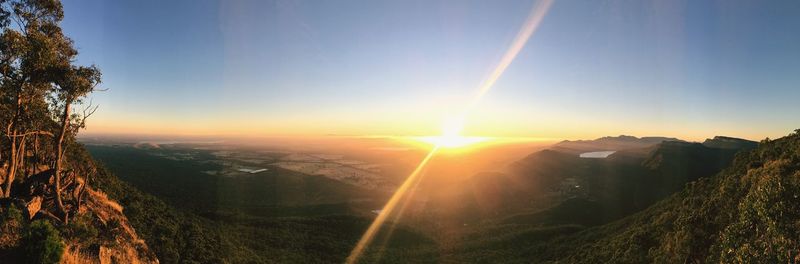 Scenic view of landscape against clear sky during sunset