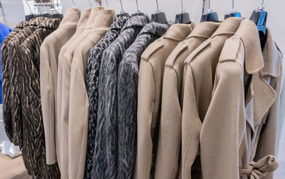 Overcoats hanging in store for sale