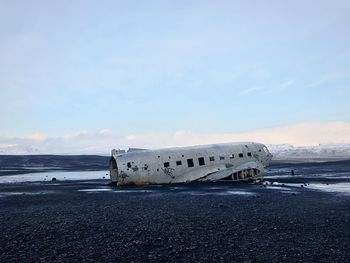 Dc-3 plane wreck on black sand beach in vik, iceland