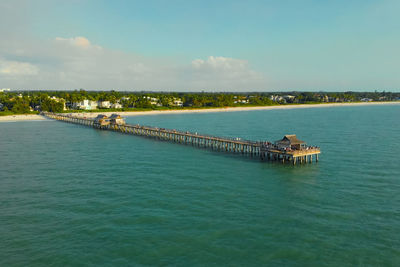 Naples beach and fishing pier at sunset, florida. sunset at the historic pier in naples. florida usa