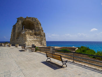 Gazebo at seaside against blue sky