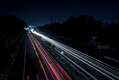 High angle view of light trails on highway at night