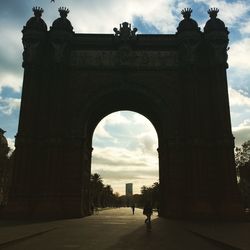 Tourists against cloudy sky