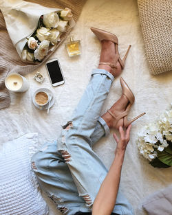 High angle view of woman wearing high heel shoes relaxing at home