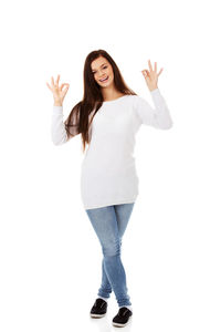 Portrait of happy woman standing against white background