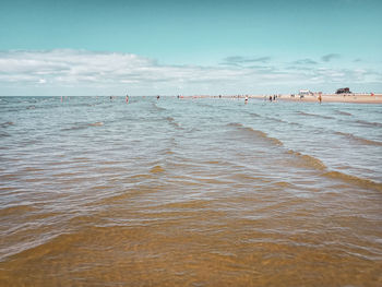 Nostalgic picture of people enjoying shallow water of st. peter-ording north sea beach at low tide