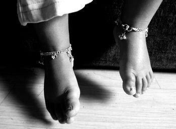 Low section of person wearing high heels standing outdoors