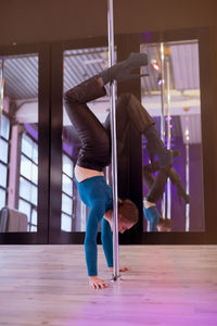 Rear view of woman exercising in gym