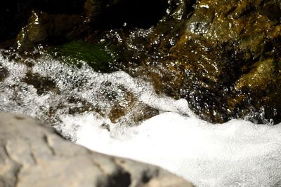 Close-up of water flowing over sea