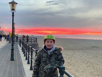 Portrait of man standing against sky during sunset