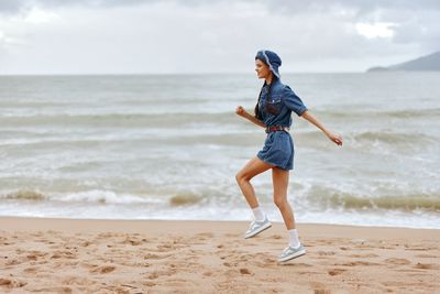 Full length of woman standing at beach