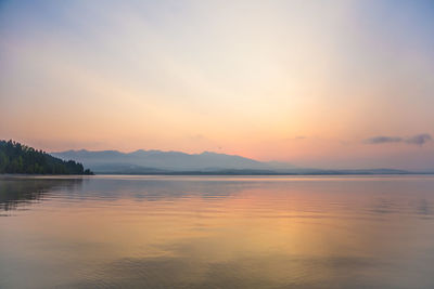 Scenic view of lake against sky during sunset