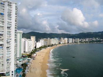 Panoramic view of beach and buildings against sky